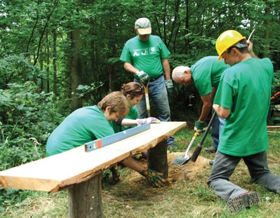 A team working near to a bench in the countryside 